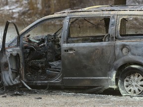 The burned out remains of a van in a parking lot at Riverside Drive and Wonderland Road on Friday January 27, 2017. (MORRIS LAMONT, The London Free Press)