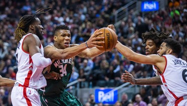 Toronto Raptors DeMarre Carroll (from left), Lucas Nogueira and Cory Joseph during 2nd half action against Milwaukee Bucks Giannis Antetokounmpo at the Air Canada Centre in Toronto, Ont. on Friday January 27, 2017. Ernest Doroszuk/Toronto Sun/Postmedia Network