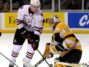 Kingston Frontenacs' Goalie Jeremy Helvig makes the save as Niagara IceDogs' Ben Jones tries to deflect the puck during Ontario Hockey League action at the Rogers K-Rock Centre on Friday. (Ian MacAlpine/The Whig-Standard)