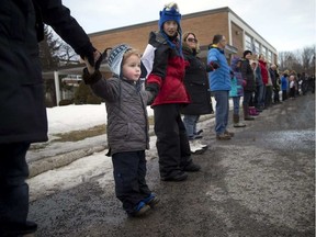 Three-year-old Tom Dulmage came out to a rally with his family to show support to keep J. H. Putman school open.
