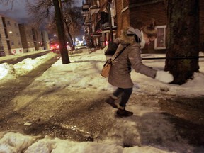 Melissa Cox watches her footing on an icy sidewalk in Montreal Sunday, January 4, 2015. (Postmedia Network file photo)