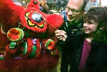 Deputy Mayor Denzil Minnan-Wong and his daughter Sally, 5, dot the eye of the dragon during the opening ceremonies for the Chinese Lunar New Year at the Dragon City Mall in Toronto on Saturday, January 28, 2017. (Veronica Henri/Toronto Sun)