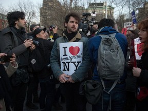 People hold signs as the Council on American Islamic Relations holds a protest against US President Donald Trump’s planned ban on Muslim travel in Washington Square Park in New York on January, 25, 2017. (BRYAN R. SMITH/Getty Images)