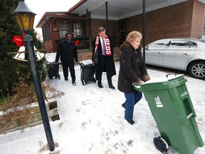 Scarborough resident Marcia Stiles had help from Councillor Michael Thompson and Mayor John Tory (c) as he announced that he would pursue contracted out garbage on the east side of the city November 21, 2016. (Michael Peake/Toronto Sun)