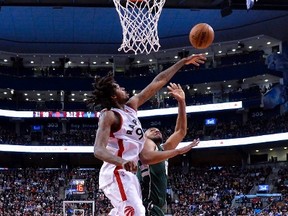 Raptors centre Lucas Nogueira rejects Milwaukee Bucks’ Jabari Parker during Friday night’s game. (THE CANADIAN PRESS)