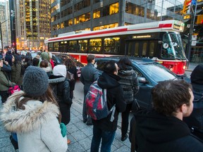 Riders wait for a TTC streetcar on King St. W. at University Ave. in Toronto on January 26, 2017. (Ernest Doroszuk/Toronto Sun)