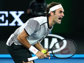 Roger Federer celebrates winning the Australian Open at Melbourne Park on January 29, 2017 in Melbourne. (Clive Brunskill/Getty Images)