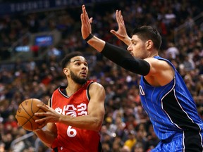 Raptors' Cory Joseph looks for a shot around Nikola Vucevic of the Magic during NBA action at the Air Canada Centre in Toronto on Sunday, Jan. 29, 2017. (Dave Abel/Toronto Sun)