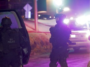 Police survey the scene of a shooting at a Quebec City mosque on Sunday January 29, 2017. (THE CANADIAN PRESS/Francis Vachon)