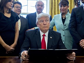 U.S. President Donald Trump pauses after signing an executive order in the Oval Office of the White House surrounded by small business leaders January 30, 2017 in Washington, DC.. Trump said he will "dramatically" reduce regulations overall with this executive action as it requires that for every new federal regulation implemented, two must be rescinded. (Photo by Andrew Harrer - Pool/Getty Images)
