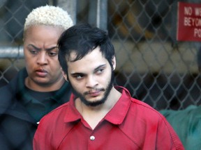 Esteban Santiago is led from the Broward County jail for an arraignment in federal court, Monday, Jan. 30, 2017, in Fort Lauderdale, Fla. Santiago is charged in a 22-count federal indictment in the Jan. 6 fatal shooting at the Fort Lauderdale-Hollywood International Airport. (AP Photo/Lynne Sladky)