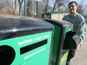 Craig Pats of Waste Management demonstrates a solar powered trash compactor at the Assiniboine Park Zoo in 2010. (MARCEL CRETAIN/Winnipeg Sun file photo)