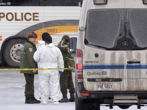 Police attend the scene of a shooting at a Quebec City mosque on Monday, which left six people dead and eight others injured Sunday. (THE CANADIAN PRESS/Paul Chiasson)