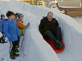 Edmonton City Councillor Ben Henderson goes for a wild ride down the ice slide outside Cafe Bicyclette in Edmonton on Monday January 30, 2017. Larry Wong/Postmedia