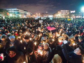People attend a vigil for victims of the mosque shooting in Quebec City Monday, January 30, 2017 in Montreal. (THE CANADIAN PRESS/Ryan Remiorz)