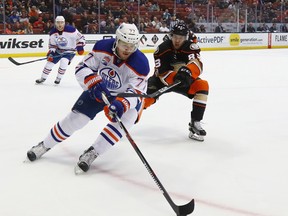 Oscar Klefbom of the Edmonton Oilers moves the puck against Kalle Kossila of the Anaheim Ducks at Honda Center on Jan. 25, 2017. (Getty Images)