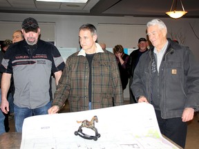 Water Wells First was on hand at a public meeting for the Otter Creek Wind Farm on Monday night in Wallaceburg at the former Baldoon Golf and Country Club. The citizen group presented a Trojan horse "Shame Award" to Boralex, one of the project's developers. Shown are group members Scott Brooksbank, left, Kevin Jakubec and Peter Hensel. (Trevor Terfloth/The Daily News)