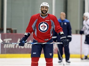 Dustin Byfuglien flashes a wide smile during Jets practice on Monday. (Kevin King/Winnipeg Sun)