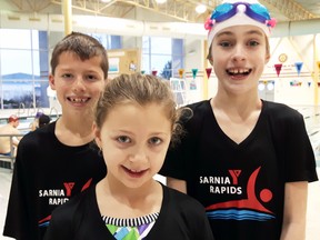From left, Sarnia Y Rapids 1 swim team members Darius Landon, 10, Ali Page, 9, and Lauren Armstrong, 9, all finished first at the under-12 celebration meet in London this past Saturday. The Sarnia team had 11 swimmers at the meet. (Handout/Sarnia Observer/Postmedia Network)