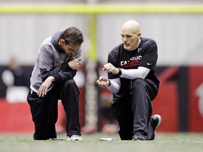 Falcons head coach Dan Quinn (right) talks with offensive coordinator Kyle Shanahan during a workout at the team's practice facility in Flowery Branch, Ga., on Friday, Jan. 27, 2017. (David Goldman/AP Photo)