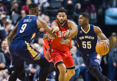 Toronto Raptors Cory Joseph during 1st half action against New Orleans Pelicans Terrence Jones (left) and E'Twaun Moore at the Air Canada Centre in Toronto, Ont. on Tuesday January 31, 2017. Ernest Doroszuk/Toronto Sun/Postmedia Network