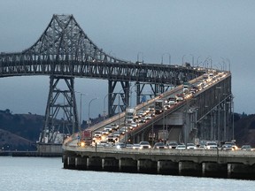 In this Aug. 29, 2013 file photo, traffic slows in the morning commute over the Richmond-San Rafael Bridge in San Rafael, Calif. A tiny unborn hummingbird is getting in the way of a big bridge project in the San Francisco Bay Area. The discovery of a nest and egg in a tree is stalling the start of upgrades on the Richmond-San Rafael Bridge about 30 miles north of San Francisco, officials said Tuesday, Jan. 31, 2017. (AP Photo/Eric Risberg, File)