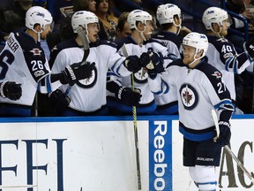 Jets forward Nikolaj Ehlers is congratulated by teammates after scoring against the Blues during second period NHL action in St. Louis on Tuesday, Jan. 31, 2017. (AP Photo/Jeff Roberson)