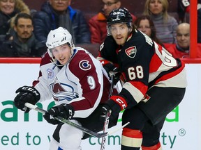 Senators left wing Mike Hoffman (68) checks Avalanche centre Matt Duchene (9) during NHL action in Ottawa last season. A report states the Sens and Avs are in the early stages of planning two games in Sweden for next season. (Errol McGihon/Postmedia/Files)
