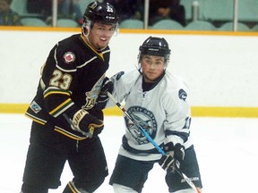 Wallaceburg Lakers defenceman Dale McMaster stays close to a Wheatley Sharks player on Wednesday, Jan. 25, at the Wallaceburg Memorial Arena. Wheatley won the game 7-2.