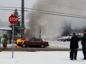 Kingston Fire and Rescue put out flames that had ignited in an man's engine on Wednesday morning. Steph Crosier, Kingston Whig-Standard, Postmedia Network