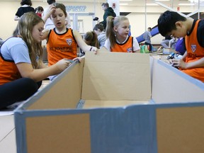 Tim Miller/The Intelligencer
Students from St. Joseph Catholic School build a cardboard boat at the Quinte Sports and Wellness Centre on Wednesday. A total of 80 Grade 7 and 8 students from six different schools worked feverishly on their designs in the hopes to stay afloat in a cardboard boat race competition put on by Skills Ontario. Winners of the competition will go on to the championships in Waterloo later this year