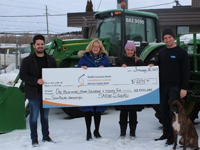 Mitch Gammon, left, general manager of Snow Squad, Mary Lou Hussak, executive director of Health Sciences North Foundation, Sally Dunton, manager of community engagement at Health Sciences North Foundation, and Taylor Marshall, owner of Snow Squad, were on hand for a cheque presentation. Supplied photo