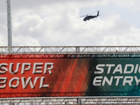 A helicopter flies over NRG Stadium in Houston ahead of the NFL's Super Bowl 51 game on Wednesday, Feb. 1, 2017. (Morry Gash/AP Photo)