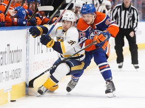 Nashville Predators' Viktor Arvidsson (38) and Edmonton Oilers' Matthew Benning (83) battle for the puck during first period NHL action in Edmonton, Alta., on Friday January 20, 2017.