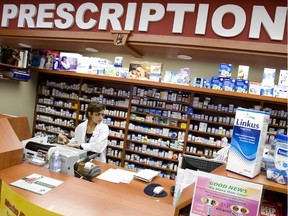 Pharmacist Dina Ghali fills prescriptions for a client at Main Drug Mart in Toronto, Friday afternoon, April 16, 2010. For weekend feature on generic-drug/ pharmacy controversy. (Aaron Lynett /Postmedia Network)