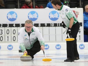 Skip Mike Harris watches a stone while lead Scott Foster gets set to sweep during the men's provincial curling championship in Cobourg, Ont., on Wednesday, Feb. 1, 2017. (Pete Fisher/Northumberland Today/Postmedia Network)