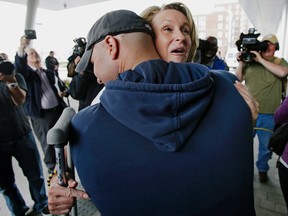 In this May 14, 2013 file photo, Boston Marathon bombing survivor Roseann Sdoia, from the North End neighborhood of Boston, is hugged and lifted off the ground by Boston firefighter Mike Meteria as she leaves Spaulding Rehabilitation Hospital in Boston. Sdoia, who lost her leg in the Boston Marathon bombing, tells The New York Post that she and firefighter Mike Materia got engaged during a trip to Nantucket in December. (AP Photo/Charles Krupa, File)