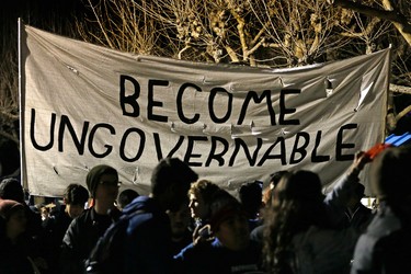 Protestors against a scheduled speaking appearance by polarizing Breitbart News editor Milo Yiannopoulos march on the University of California at Berkeley campus Wednesday, Feb. 1, 2017, in Berkeley, Calif. The event was canceled out of safety concerns after protesters hurled smoke bombs, broke windows and started a bonfire. (AP Photo/Ben Margot)