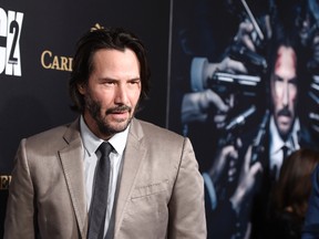 Keanu Reeves, a cast member in "John Wick: Chapter 2," arrives at the premiere of the film at ArcLight Cinemas on Monday, Jan. 30, 2017, in Los Angeles. (Photo by Chris Pizzello/Invision/AP)