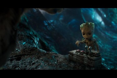 Baby Groot trying to figure out which button to push in a scene from Marvel's Guardians of the Galaxy Vol. 2. (Marvel Studios)