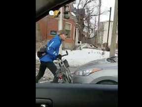 Screen capture from video uploaded to Twitter of a confrontation between a cyclist and driver on Bronson Avenue in January. KRISTY CAMERON / TWITTER/@CFRAKRISTY