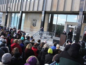 People gathered at a solidarity rally at city hall Thursday sing 'O Canada' while denouncing the recent Quebec mosque massacre that left six men at prayer shot dead. Another solidarity event and open house is planned Feb. 8 at the Sarnia Muslim Association mosque. (Tyler Kula/Sarnia Observer/Postmedia Network)
