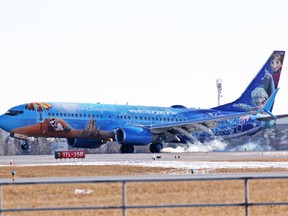 WestJet's 'Frozen'-themed plane touches down at Calgary International Airport after reports of smoke in the cabin. (Gavin Young/Postmedia Network)