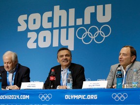 In this Feb. 18, 2014, file photo, NHLPA executive director Don Fehr, left, IIHF president Rene Fasel, center, and NHL commissioner Gary Bettman answer questions during a news conference at the Olympics in Russia. (AP Photo/Mark Humphrey, File)