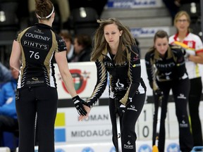 Skip Rachel Homan gives Joanne Courtney a "low five" before Homan takes her shot. The Recharge With Milk Tankard (Provincial Men's Curling Championship) and the Scotties Tournament of Hearts Provincial Women's Championship continues at the Cobourg Community Centre in Cobourg. (Pete Fisher/Postmedia Network)