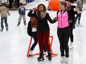 Kreesha Dizon, left, and Jordi Cocks practice their dance moves as they take part in the Valentine's Day Disco Skate event at the City Hall skating rink in Edmonton, Alta. on Thursday, Feb. 14, 2013. David Bloom/Edmonton Sun