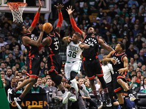 Boston Celtics guard Marcus Smart dumps off the ball as he is pressured by the Toronto Raptors during an NBA game on Feb. 1, 2017. (AP Photo/Charles Krupa)