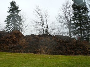 Mounds of manure are shown in this image from along a property line in Indian Mountain, N.B. on Nov. 18, 2013. (THE CANADIAN PRESS/Dave Gallant)