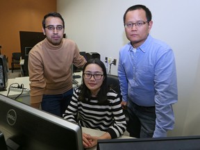 Yang Wang (right), a professor in the department of computer science at the University of Manitoba, with students Bingling Li (centre) and Mehrdad Hosseinzahed, in a computer lab on campus on Thu., Feb. 2, 2017. The students are working on software to help identify undetected child sexual abuse images and prevent distribution. Kevin King/Winnipeg Sun/Postmedia Network