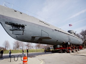Workers at the Museum of Science and Industry move a captured Second World War German submarine along a road outside the museum April 9, 2004 in Chicago, Illinois. (Photo by Scott Olson/Getty Images)